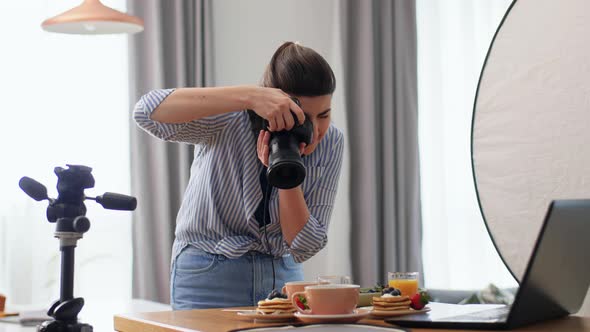 Female Food Photographer with Laptop in Kitchen