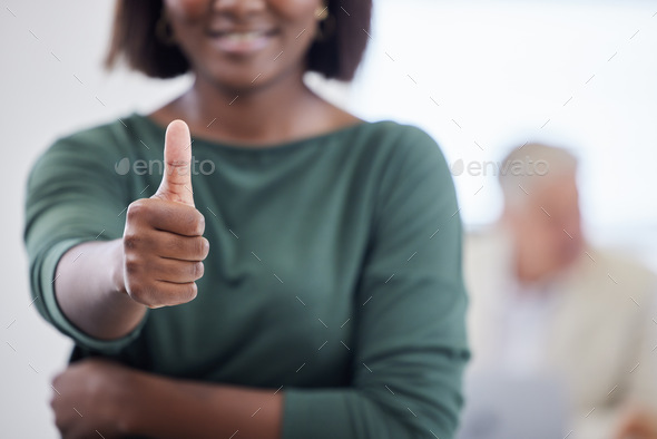Shot of an unrecognisable businesswoman showing thumbs up during a meeting in a modern office