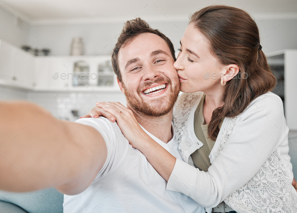 Youve stolen a pizza of my heart. Portrait of a young couple relaxing on a sofa at home.