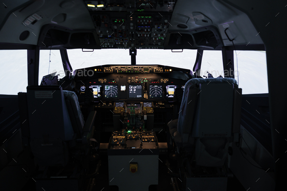 No people in empty captain cabin used to fly airplane with dashboard