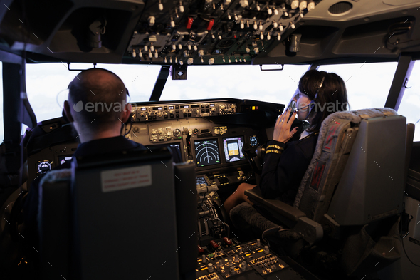 Male captain and copilot flying airplane with control command
