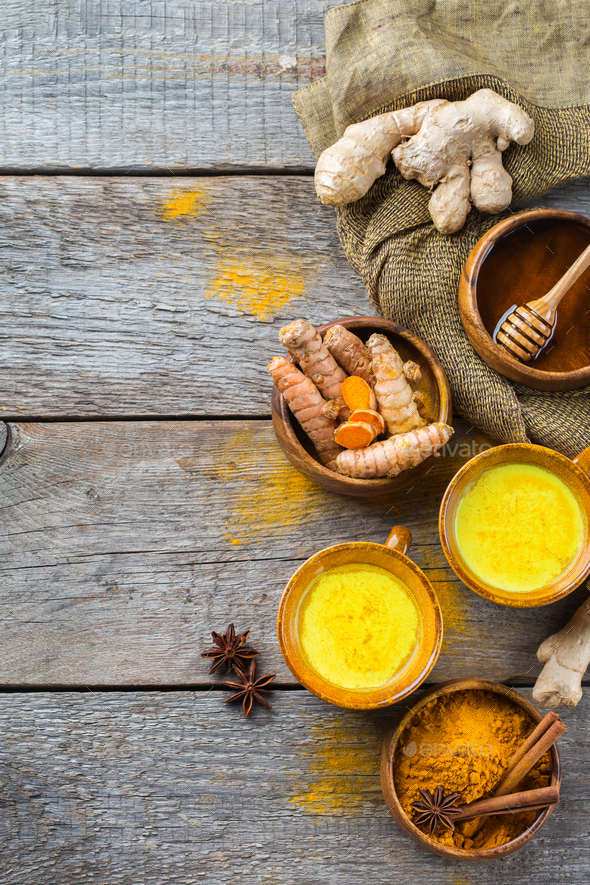 Traditional indian drink turmeric curcuma golden milk with ingredients