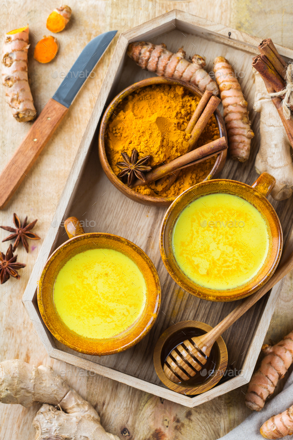 Traditional indian drink turmeric curcuma golden milk with ingredients