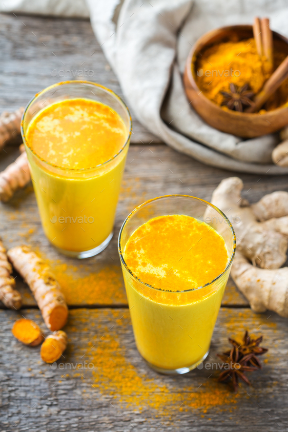 Traditional indian drink turmeric curcuma golden milk with ingredients