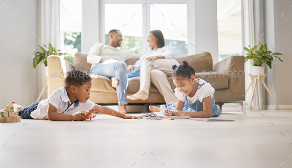 Shot of two children playing while parents talk at home