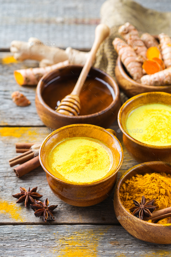 Traditional indian drink turmeric curcuma golden milk with ingredients