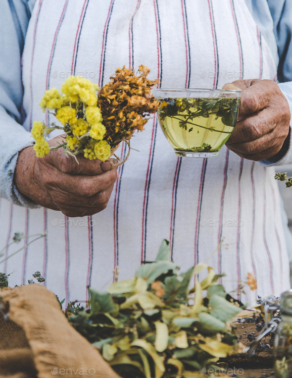 Grandmother makes tea with medicinal herbs. Selective focus.
