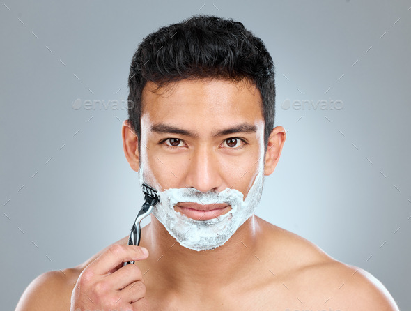 Shaving makes us feel brand new. Studio shot of a man shaving with a disposable razor.