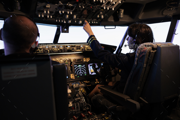 Captain and copilot switching power engine buttons on dashboard Stock ...