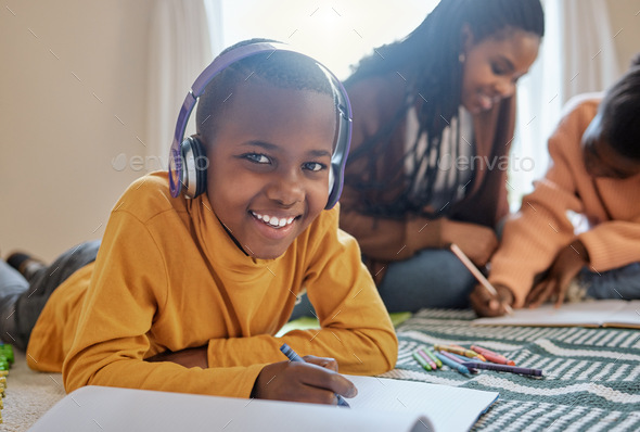 Music makes the work easier. Shot of a young boy completing school work while listening to music.