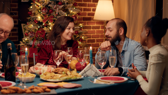 Joyful wife and husband talking at home while enjoying Christmas dinner together