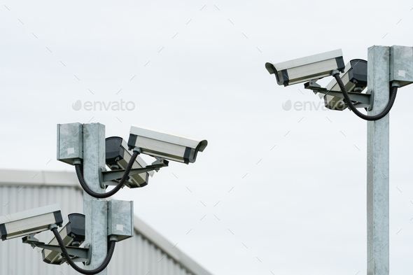 CCTV security camera video system for safety installed outside the warehouse of factory building.  - Stock Photo - Images
