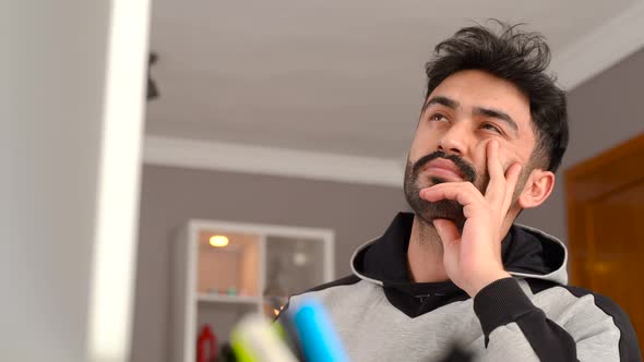 Thoughtful and tired home office worker. alt