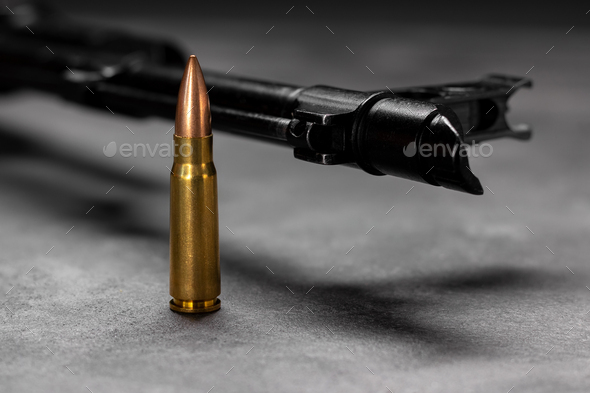 Bullet against Kalashnikov assault rifle - Stock Photo - Images