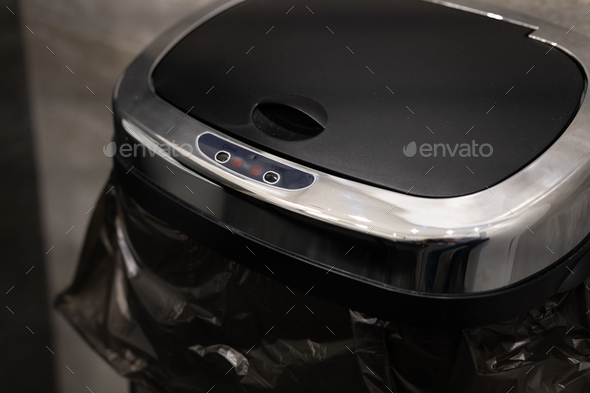 trash can with touch-sensitive automatically opening lid. smart modern technology in home