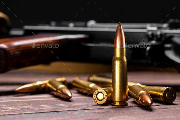 Bullets against Kalashnikov assault rifle - Stock Photo - Images