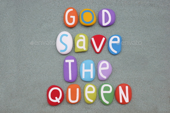 God save the Queen, creative slogan composed with multi colored stone letters over green sand