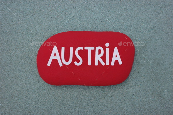 Austria, country name colored on a red stone over green sand