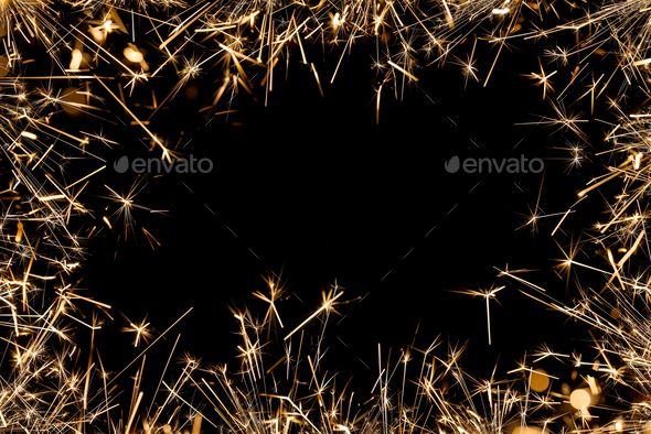 Frame of firework sparklers over black