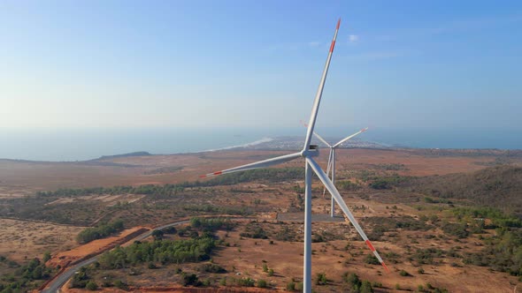 Aerial Shot of a Group of Wind Turbines in a Semidesert Environment alt