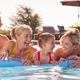 Smiling Multi-Generation Family On Summer Holiday Relaxing In Swimming Pool On Airbed - PhotoDune Item for Sale