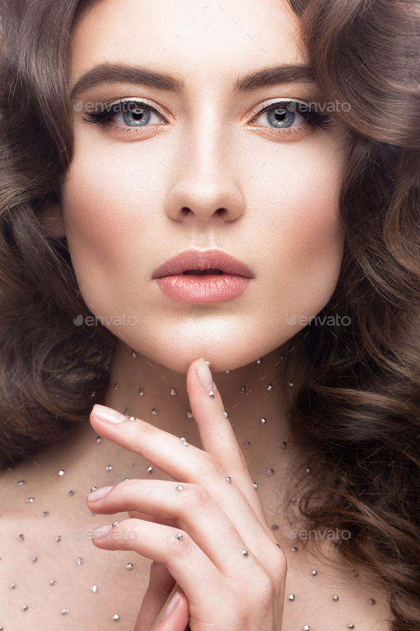 Portrait Of Beautiful Girl With A Gentle Makeup Curls And Crystals On