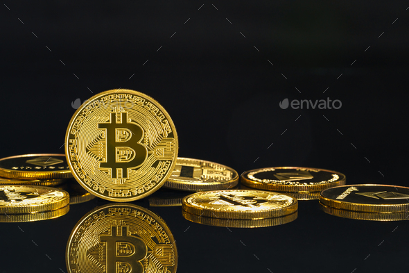 Golden coins with Bitcoin cryptocurrency symbol on black