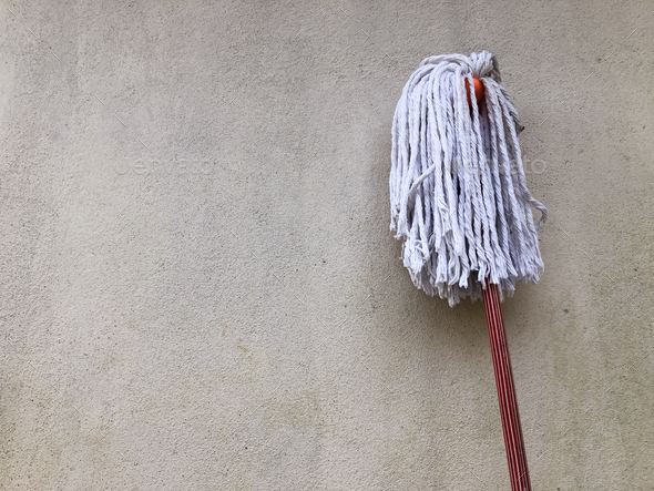 Classic mop with cotton head on wall