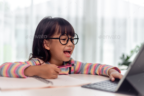 Asian little girl taking class on line and happy for Homeschool Quarantine