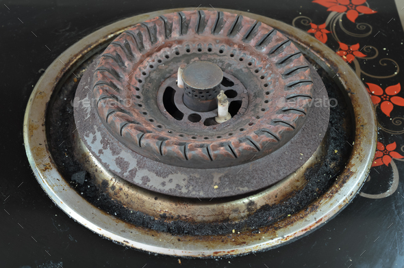 Grunge stove pan with fat stains, fry spots, oil splatters and burned-on bits