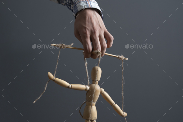 a hand manipulate threaded puppet marionette, human manager master