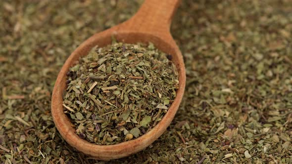 Herbs of Provence seasoning for food in wooden spoon and on background rotation alt