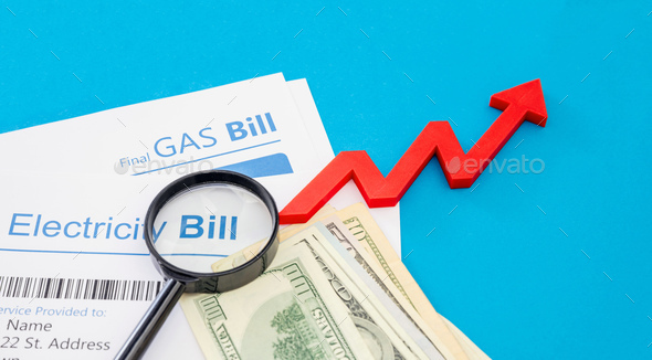 Electricity and gas bills and US dollars banknotes. Household cost increase