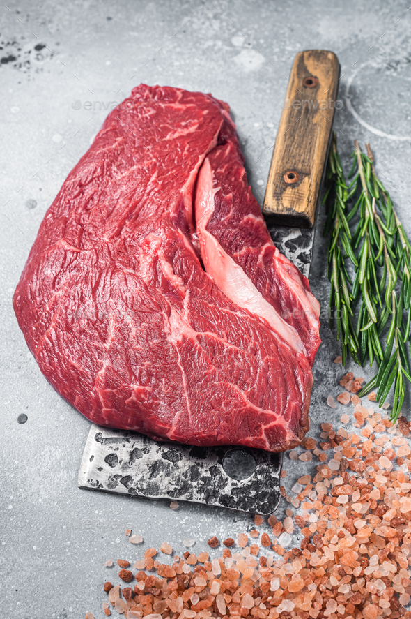 Butcher board with raw prime beef steak top sirloin or rump with pink salt and rosemary. Stock