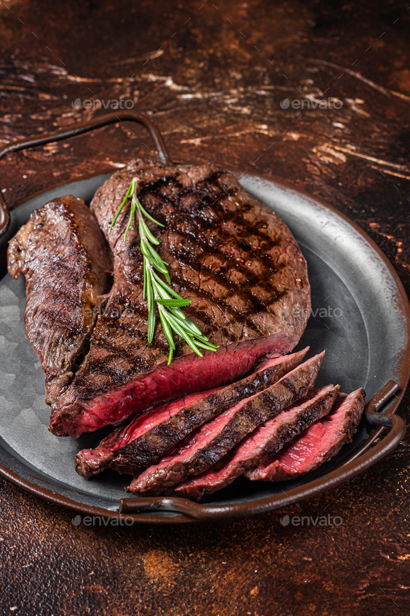 Grilled Medium Rare top sirloin beef steak or rump steak on a steel