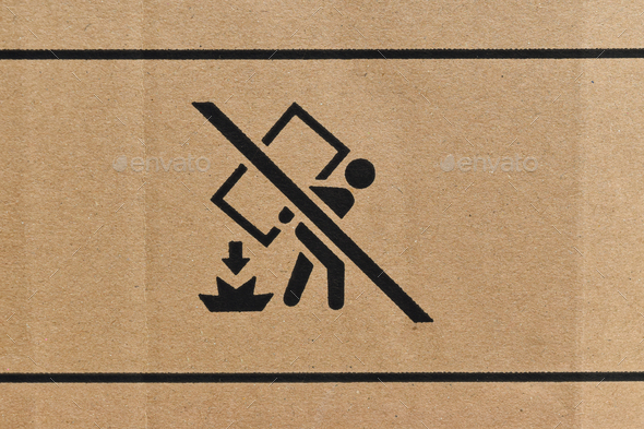 Close Up of cardboard box with packaging symbols as background.