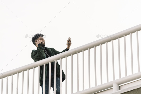 black man listening music or making video call