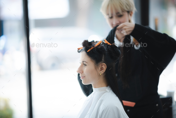 professional fashion hairdresser and hair beauty salon, hairstylist making treatment to client