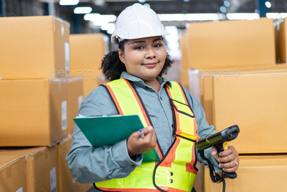 Portrait of African female worker in safety uniform holding checklist clipboard