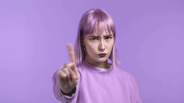 Portrait of Serious Trendy Woman Showing Rejecting Gesture By Stop Finger Sign alt