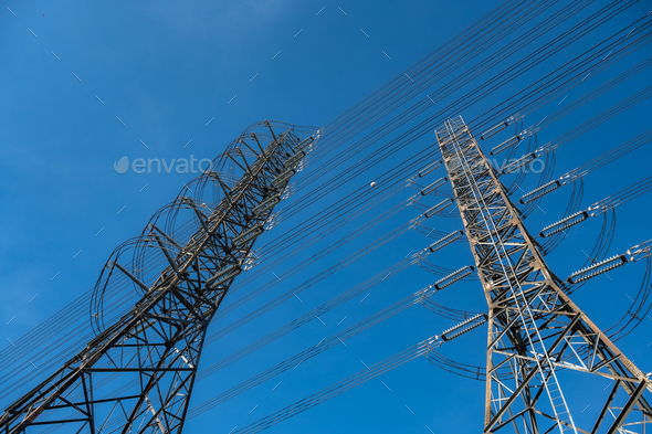 Closeup of communication and satellite tower with connecting wires transferring electricity