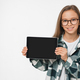 Smiling caucasian preteen teenage girl schoolgirl using digital tablet showing device screen mockup - PhotoDune Item for Sale