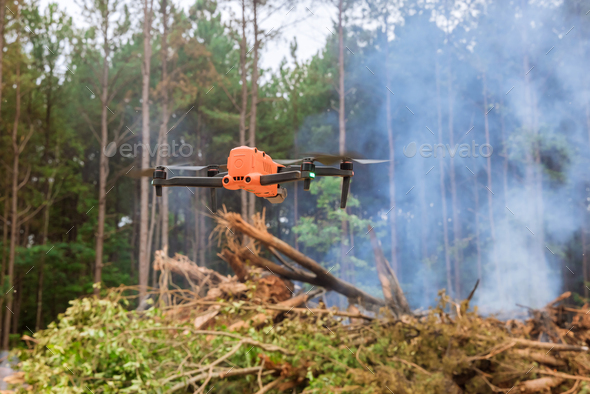 With the help of drones, the fire services track the fire into the forest trees