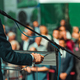 Male Speaker Standing In Front Of Microphones - PhotoDune Item for Sale