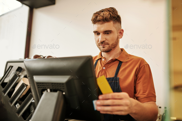 Coffeeshop Worker Checking Cashier Desk
