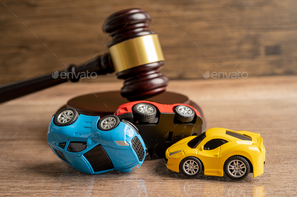 Hammer gavel judge with car vehicle accident, insurance coverage claim lawsuit court case.