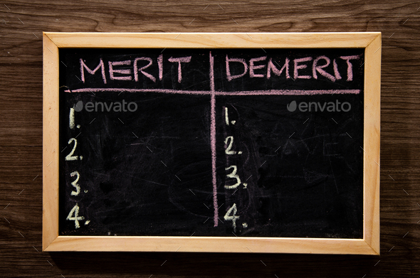 blackboard with merit and demerit words - Stock Photo - Images