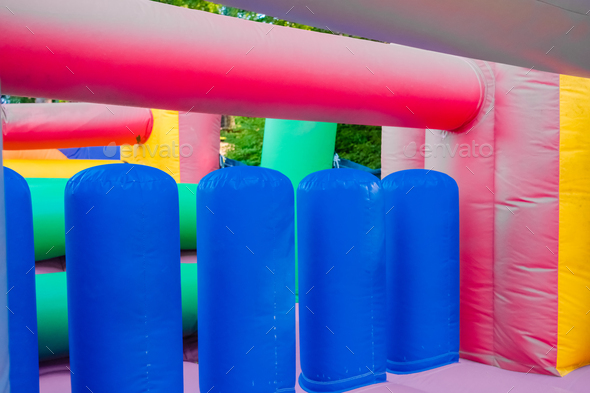 Detail of a brightly colored bouncy castle, empty without children.