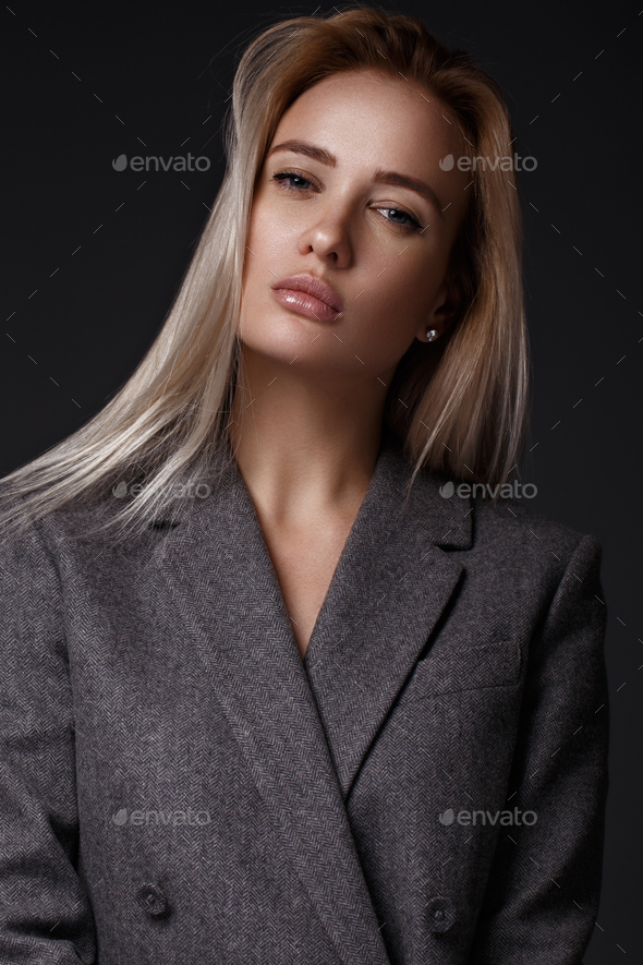 They perfect their poses together. Studio shot of two beautiful young women  posing against a grey background Stock Photo - Alamy