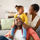 Little black girl playing with parents at home - PhotoDune Item for Sale